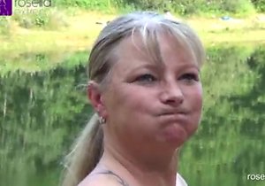 Blond-haired mature sucking dick while outdoors